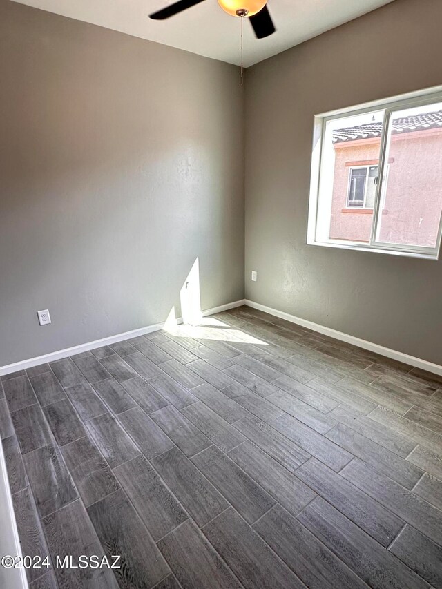 unfurnished room featuring dark hardwood / wood-style flooring and ceiling fan