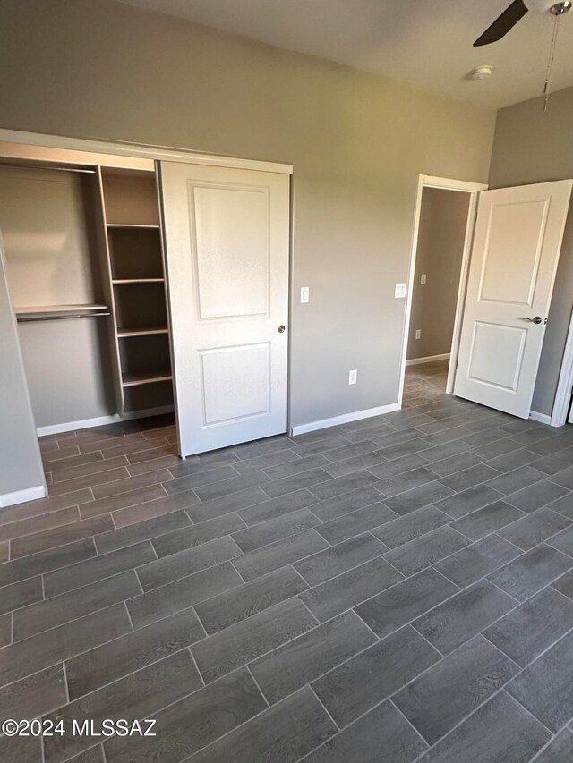 unfurnished bedroom featuring ceiling fan, dark hardwood / wood-style floors, and a closet