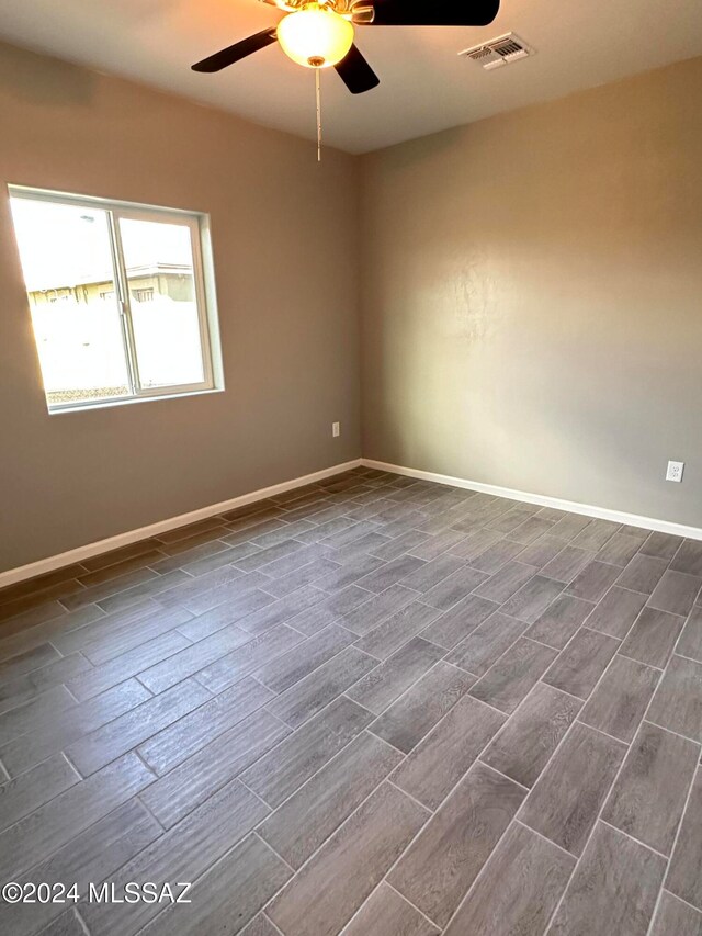 spare room featuring dark hardwood / wood-style floors and ceiling fan