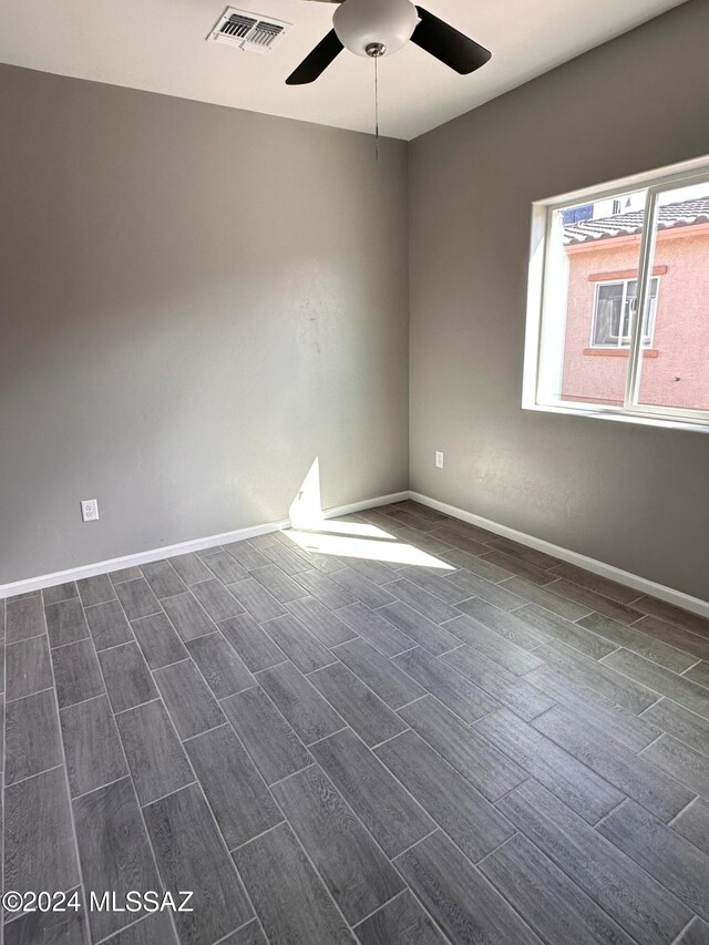 spare room with ceiling fan and dark hardwood / wood-style floors