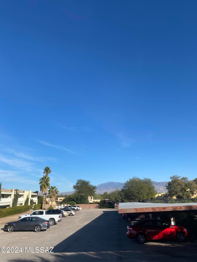 view of car parking featuring a mountain view