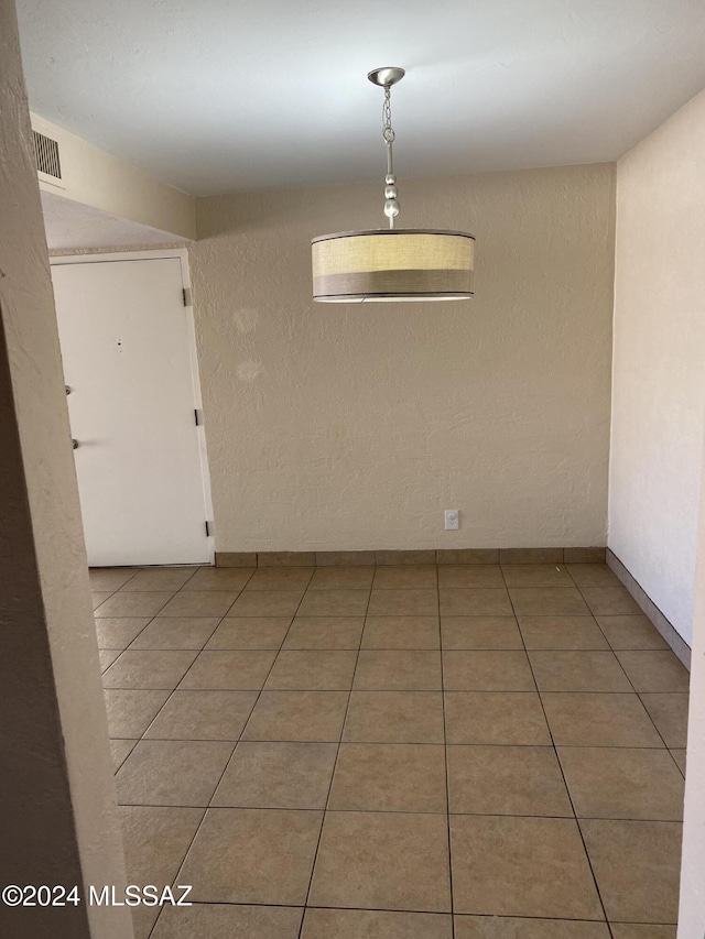 625 S Prudence Rd Unit 209, Tucson, AZ 85710 - spare room with light tile patterned flooring and a textured wall