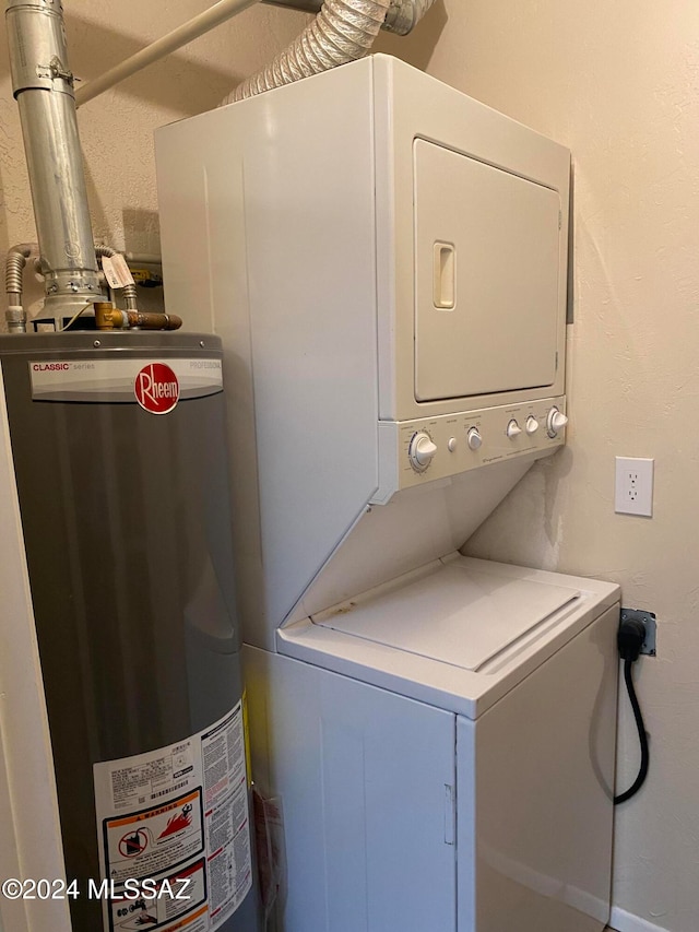 laundry area with gas water heater and stacked washer / dryer