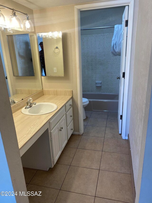 full bathroom with tile patterned floors, vanity, toilet, and tiled shower / bath combo