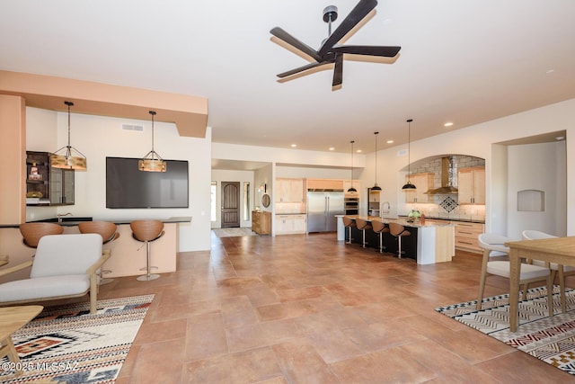 living room with sink and ceiling fan