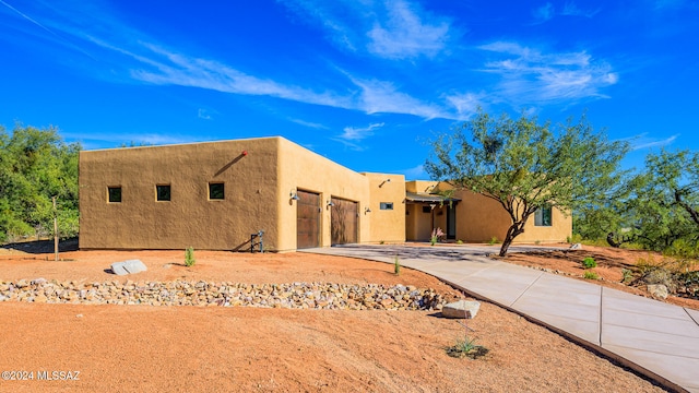 pueblo-style house with a garage