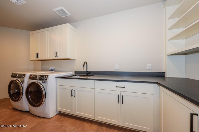 laundry room featuring cabinets, sink, and independent washer and dryer