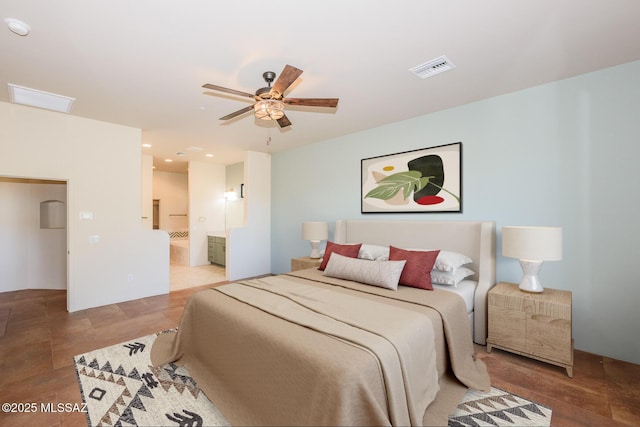 bedroom with ceiling fan and ensuite bath