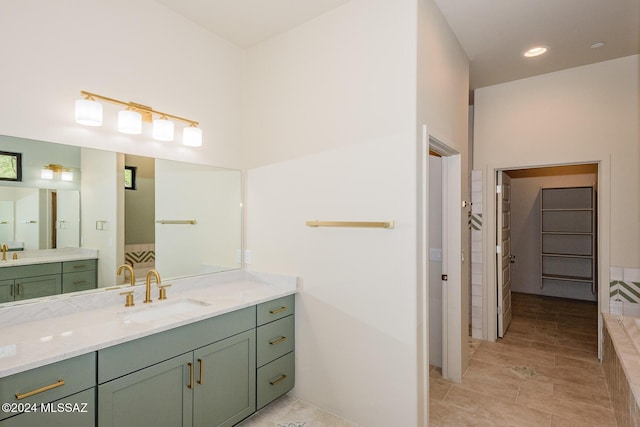 bathroom featuring vanity and a relaxing tiled tub