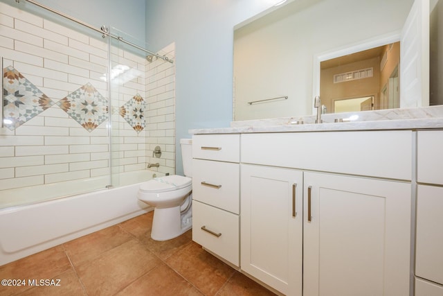 full bathroom with vanity, combined bath / shower with glass door, tile patterned floors, and toilet