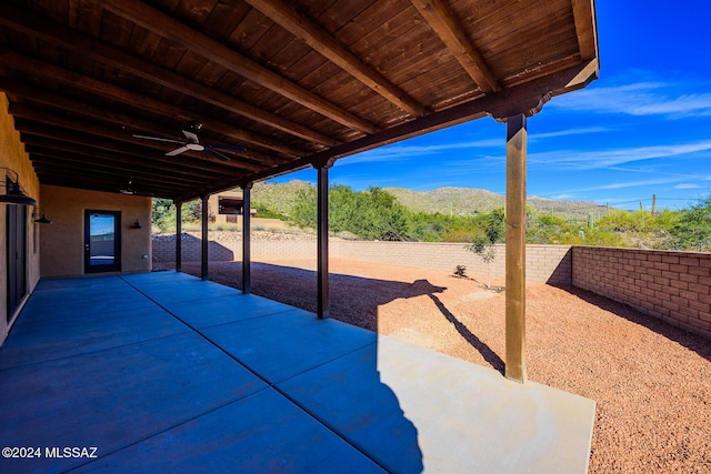 view of patio featuring ceiling fan and a mountain view