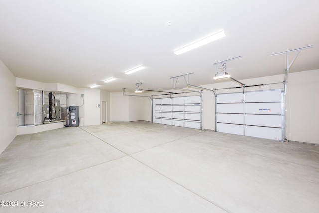 garage with a garage door opener, electric water heater, and heating unit