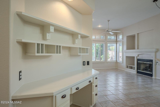 kitchen with ceiling fan, light tile patterned floors, and cream cabinets