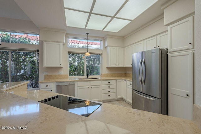 kitchen featuring light stone counters, sink, white cabinets, and appliances with stainless steel finishes