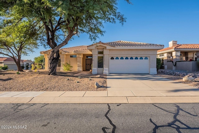 mediterranean / spanish-style home featuring a garage