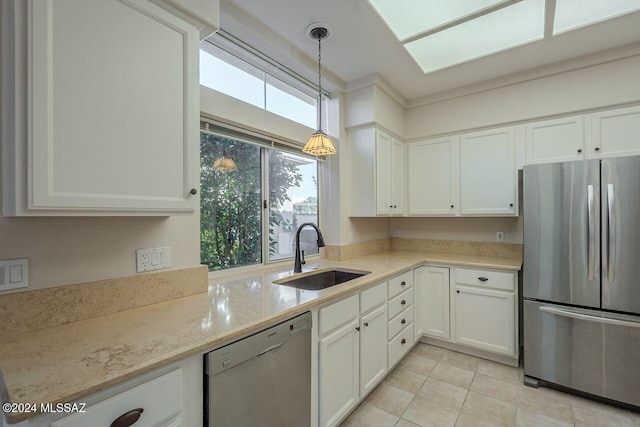 kitchen featuring sink, stainless steel fridge, white dishwasher, pendant lighting, and white cabinets