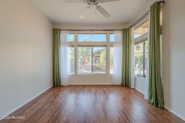 unfurnished room featuring hardwood / wood-style flooring, plenty of natural light, and ceiling fan