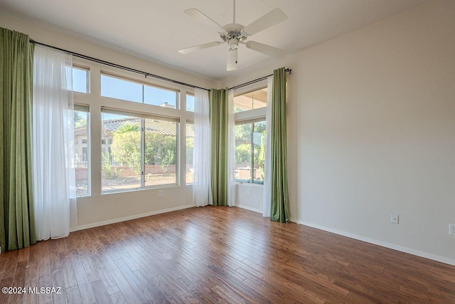 spare room with hardwood / wood-style flooring and ceiling fan