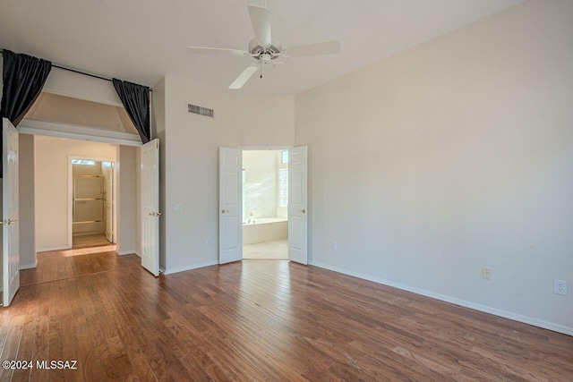 spare room featuring ceiling fan and dark wood-type flooring