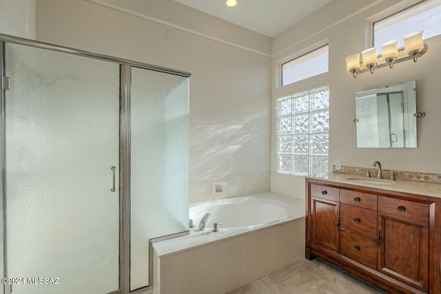 bathroom with shower with separate bathtub and vanity