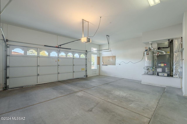 garage with heating unit, a garage door opener, and gas water heater