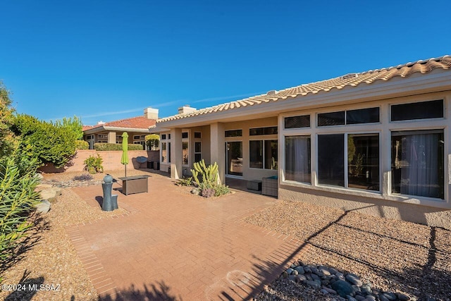 rear view of property featuring a patio area