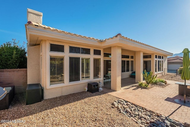 rear view of property featuring a patio area