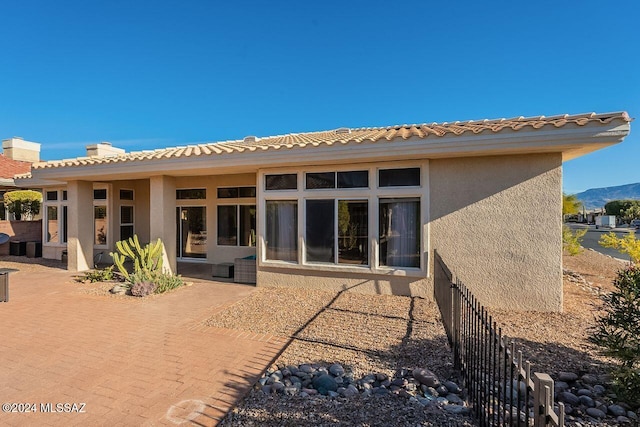 back of property featuring a mountain view