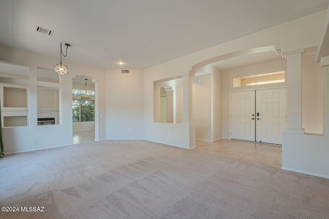 unfurnished living room featuring light colored carpet