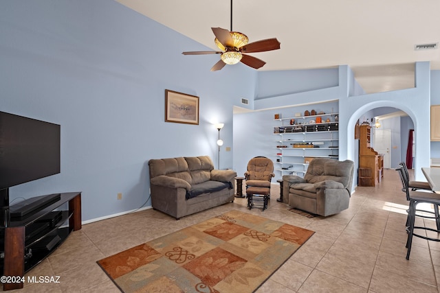 living room featuring ceiling fan, light tile patterned floors, and high vaulted ceiling