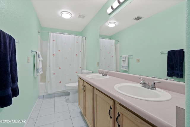 full bathroom featuring tile patterned floors, shower / tub combo with curtain, vanity, and toilet