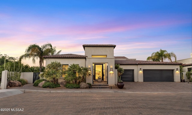 mediterranean / spanish home featuring a garage