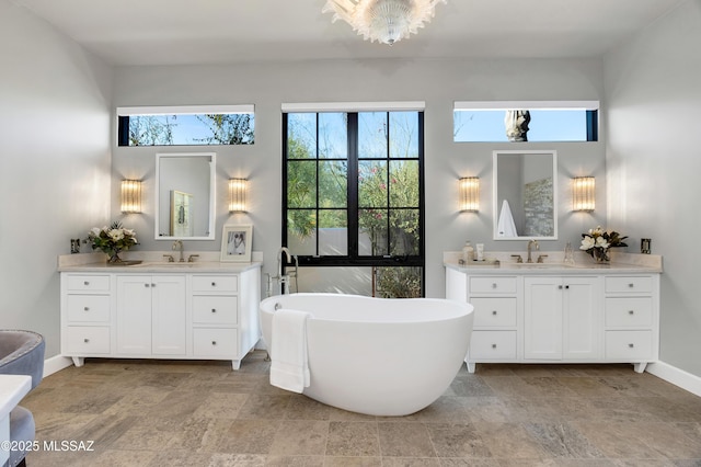 bathroom with a tub to relax in and vanity