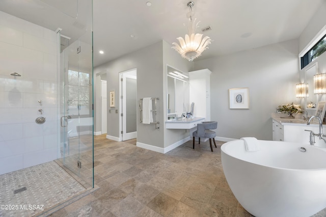 bathroom with vanity, a notable chandelier, and independent shower and bath