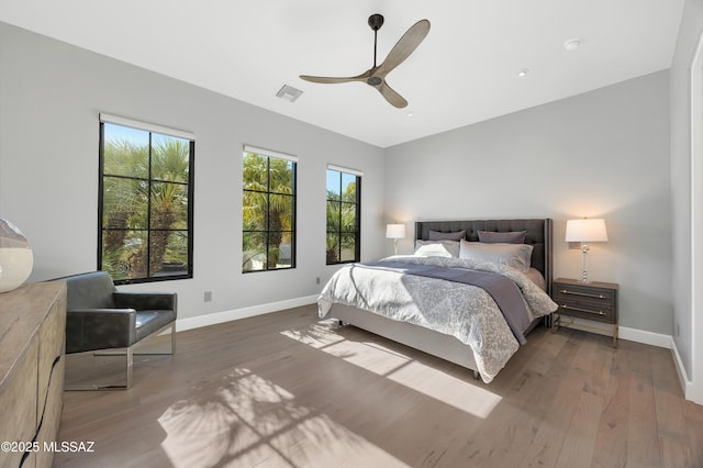 bedroom with ceiling fan and hardwood / wood-style flooring