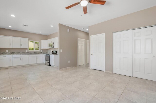 kitchen with visible vents, light stone countertops, stainless steel appliances, white cabinetry, and recessed lighting