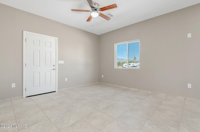 unfurnished living room featuring a healthy amount of sunlight, ceiling fan, and light tile patterned floors