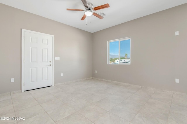 spare room with ceiling fan and visible vents