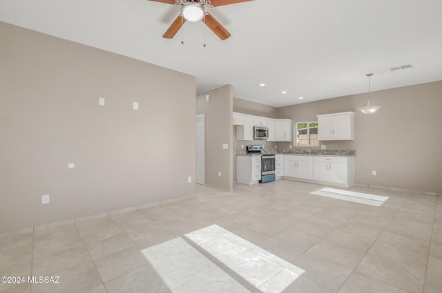 kitchen featuring stainless steel appliances, visible vents, white cabinets, open floor plan, and decorative light fixtures