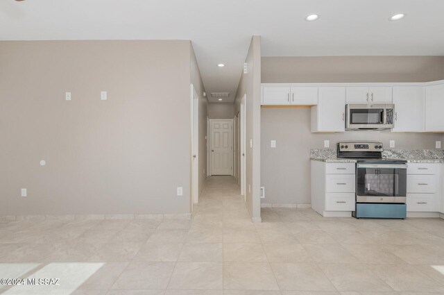 tiled spare room featuring ceiling fan