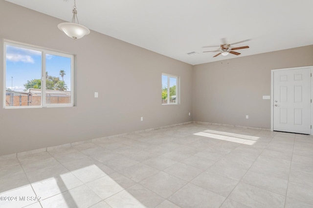 unfurnished room with a ceiling fan and visible vents