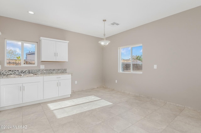 unfurnished dining area with light tile patterned floors, a sink, visible vents, and recessed lighting