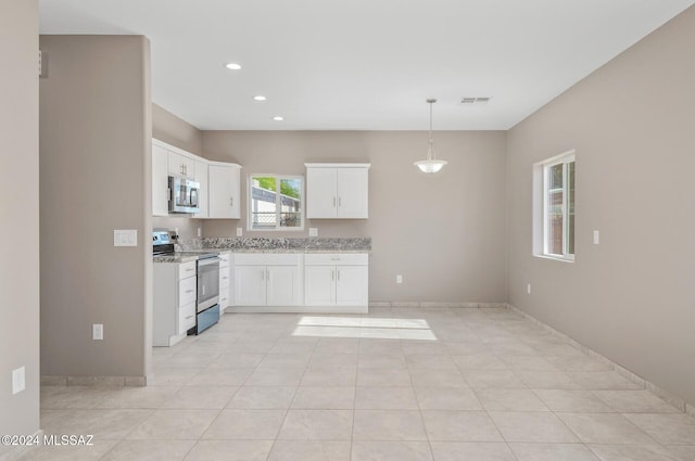 kitchen featuring light stone counters, decorative light fixtures, recessed lighting, appliances with stainless steel finishes, and white cabinetry