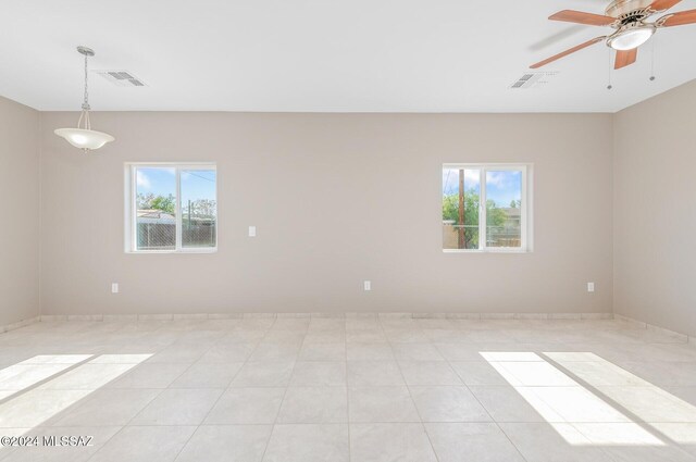 spare room featuring ceiling fan and light tile patterned floors