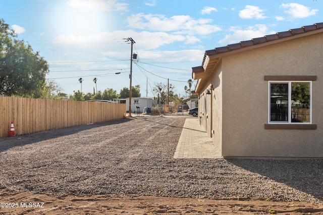 view of yard featuring fence and a patio