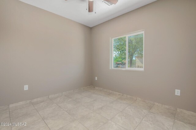 unfurnished bedroom with light tile patterned floors, ceiling fan, vaulted ceiling, and a closet