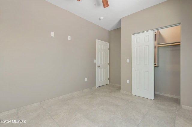 unfurnished bedroom with a closet, ceiling fan, and baseboards