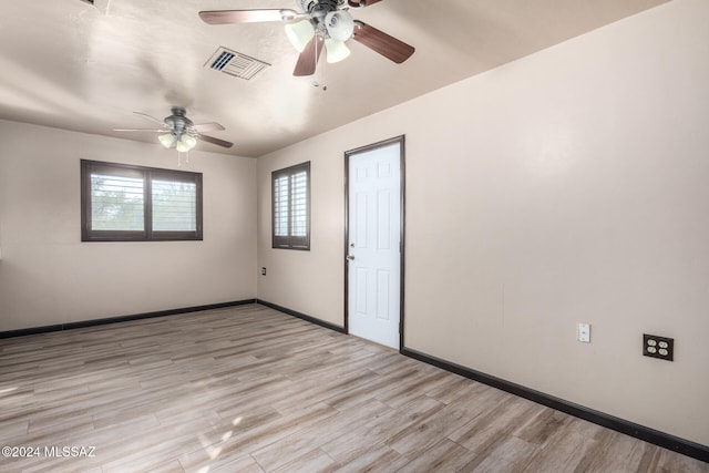 spare room featuring ceiling fan and light wood-type flooring