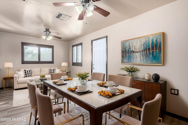 dining area with hardwood / wood-style flooring and ceiling fan