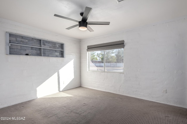 empty room featuring carpet flooring and ceiling fan